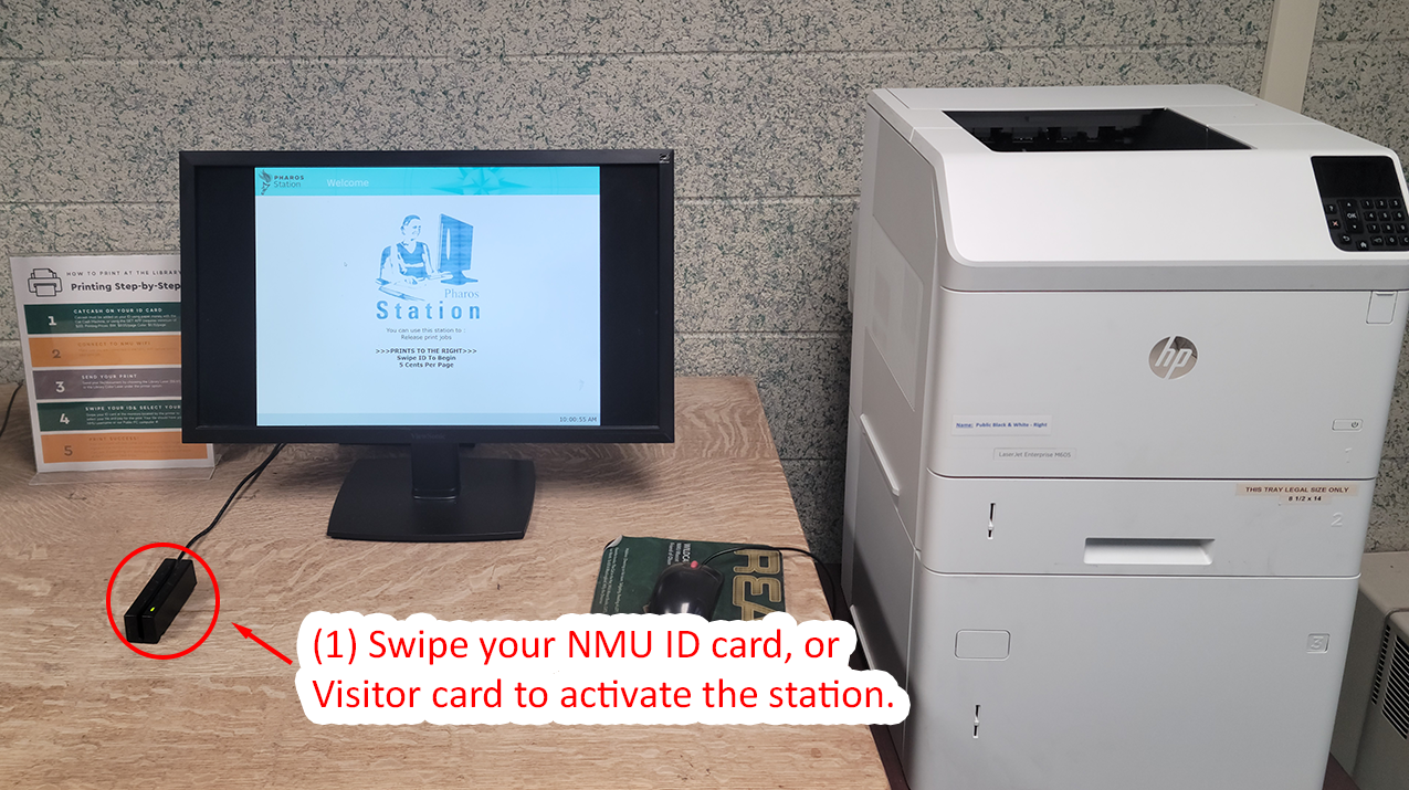 Library printing station showing a monitor, card reader, and printer with swipe card instructions