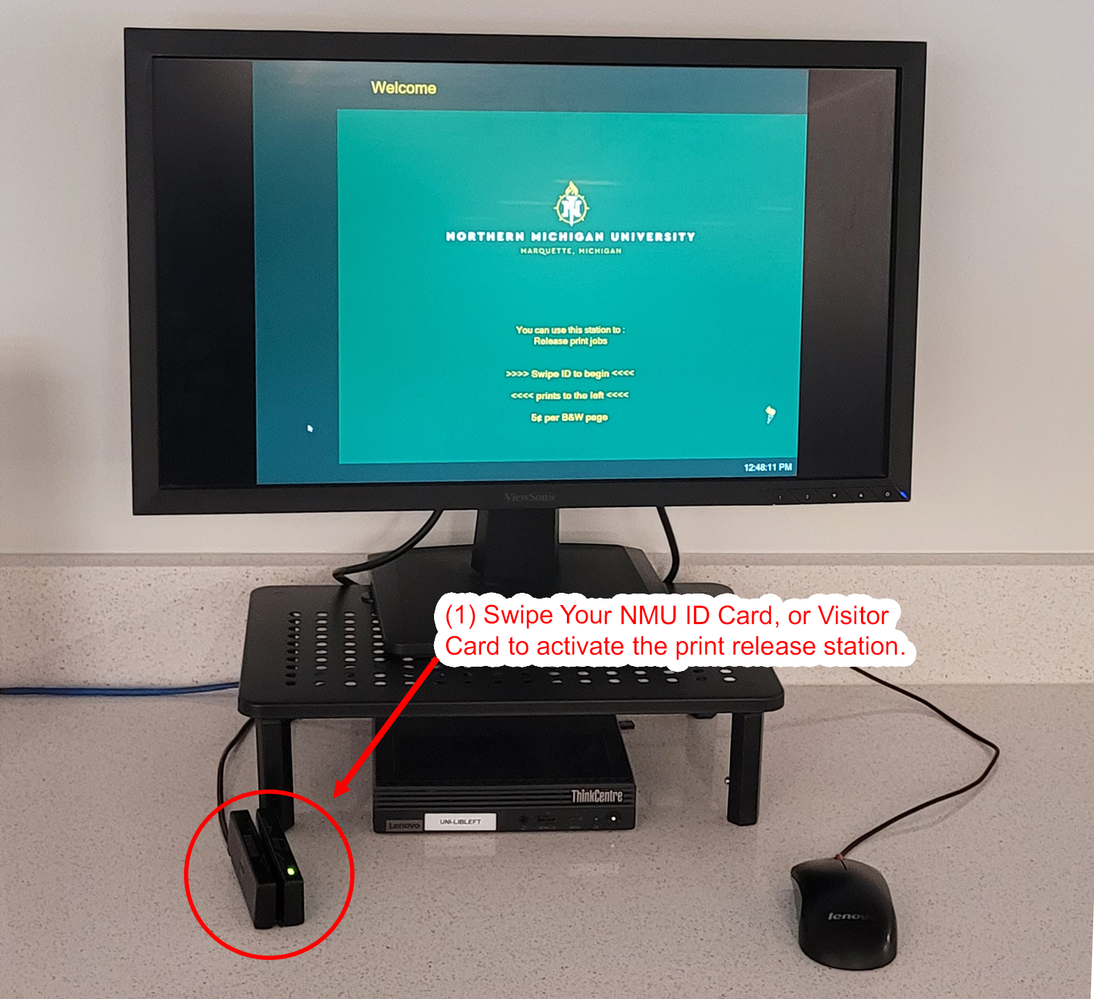 Computer monitor at NMU print release station with card reader below screen.