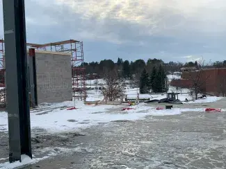 Snow-covered, open third floor exposed to the weather, set to become a classroom in a year.