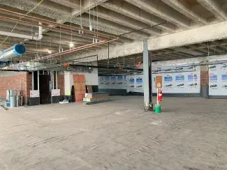 Second floor construction area with an exposed ceiling and roofing material covering the floor.