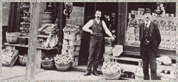 Two men standing outside a storefront